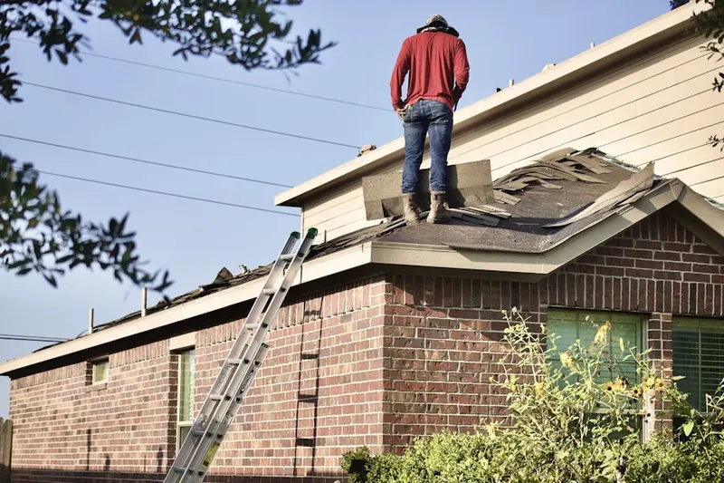 Professional roofer working on a residential roof in East Morris